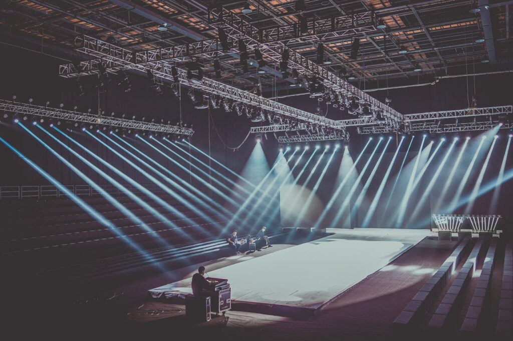 An expansive indoor stage with dramatic lighting setup, ready for a performance or event.